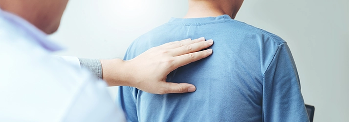 Chiropractic Bakersfield CA Back Exam Patient in a blue shirt receiving a back exam.