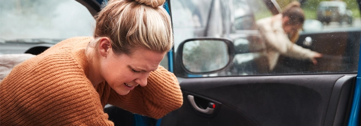 Chiropractic Bakersfield CA Car Accident Person holding their neck after a car accident.