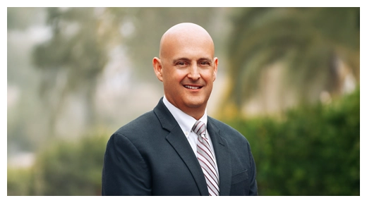 Chiropractor Christopher Berry smiling outside.